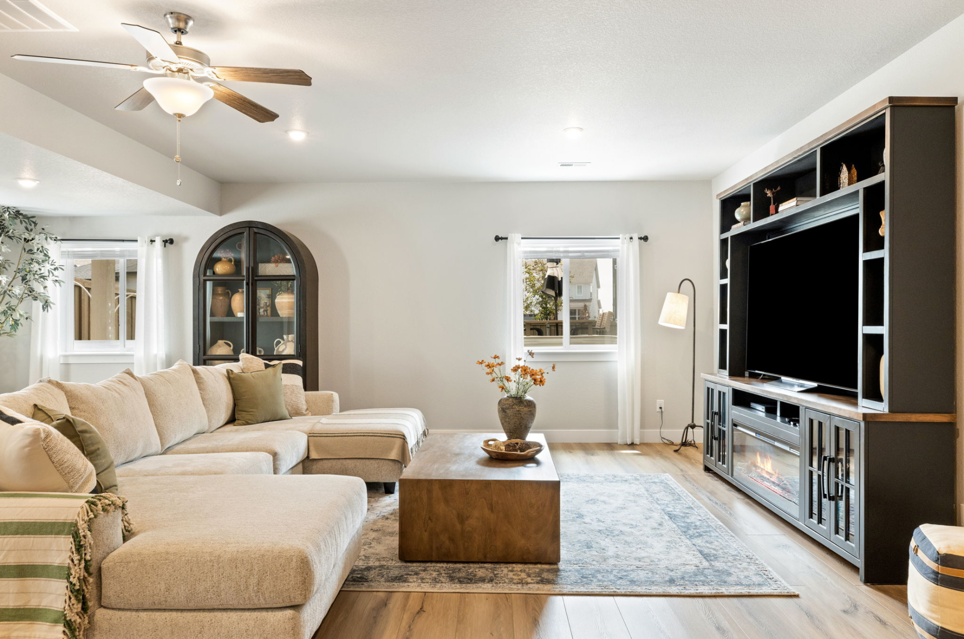 Living room at 7991 Pennydale Drive in Sterling Ranch with gas fireplace, large windows, and open ranch-style layout