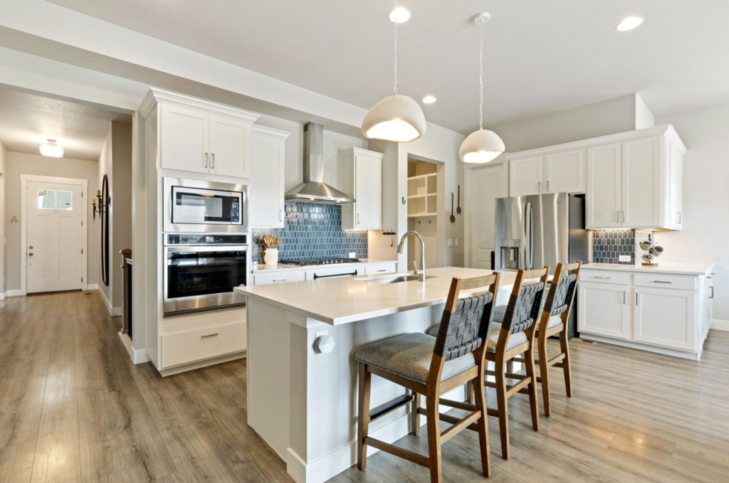 Kitchen at 7991 Pennydale Drive in Sterling Ranch with large island, solid surface countertops, and stainless steel appliances